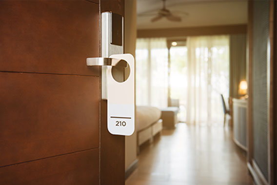 A view into a contractor hotel room, through the open door with keycard