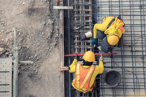 Two contractors installing foundations, viewed from above